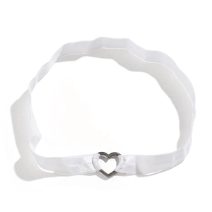 Détail d'une bande de cuisse élastique blanche avec boucle en métal argenté poli en forme de cœur