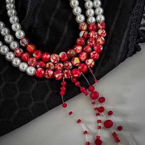 Detail view of gothic choker with white pearls, red marble beads and fringe tassels