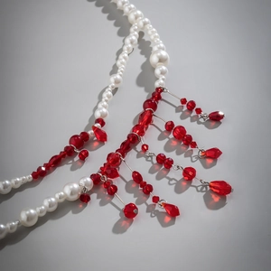 Detail of beaded gothic choker with white pearls and red blood-drop crystal tassels