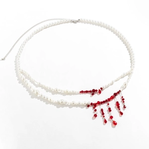 Detail of gothic waist chain with white pearls and red blood drop bead tassels
