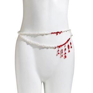 Detail of Gothic layered pearl waist chain featuring red crystal blood drip tassels