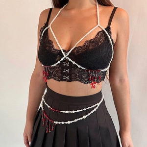 Detail of gothic lace vest and choker with pearl tassels and red crystal drops