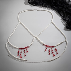 Detailed view of pearl body chain with red crystal pendants and adjustable silver clasp
