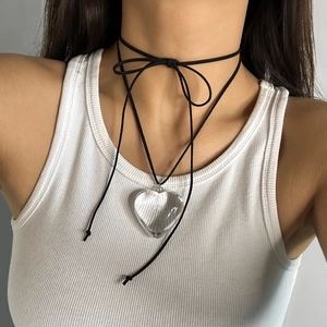 Close-up of adjustable black wax cord choker with a large clear heart-shaped pendant