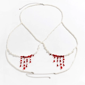 Detail of beaded body chain with white pearls and red teardrop tassel pendants