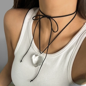 Detail of adjustable black cord choker featuring a large transparent heart resin pendant