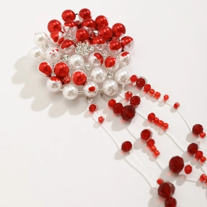 Detail of Gothic pearl choker featuring red bead tassels and clear crystal accents