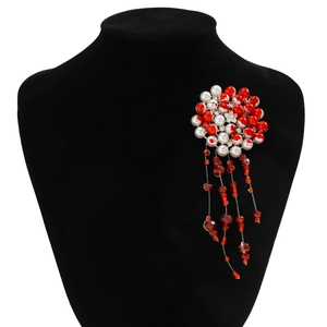 Detailed view of gothic red pearl flower choker with dripping bead tassels on black stand