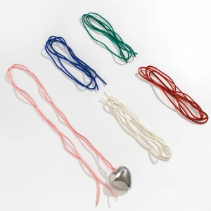 Detailed view of polished silver heart pendant with colorful adjustable wax cord options