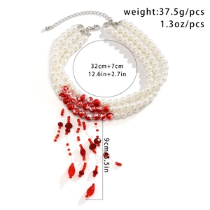 Detailed view of triple-layer pearl choker with red bead tassels and dimensions