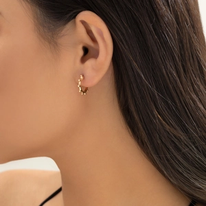 Detail of vintage French style gold hoop earrings with small bead studs on model