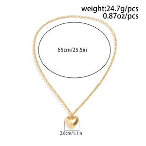 Detail view of large gold heart pendant necklace showing 65cm chain length and 24.7g weight