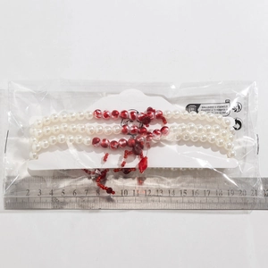 Detailed view of gothic blood drop choker with red heart pendant and measuring ruler