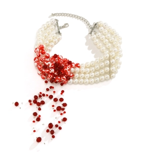 Detail of four-row pearl choker featuring red bead floral clusters and drop fringe