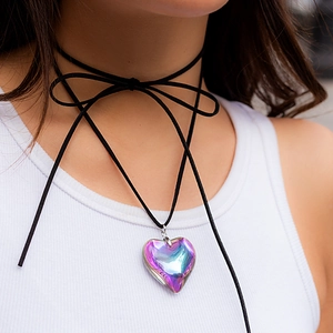 Close-up of holographic heart pendant with black velvet bow choker on a female model