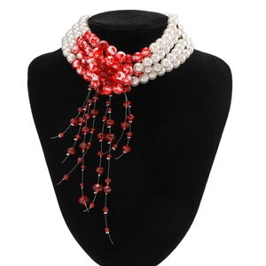 Detailed view of Gothic multi-layer pearl choker with red flower motif and bead tassels