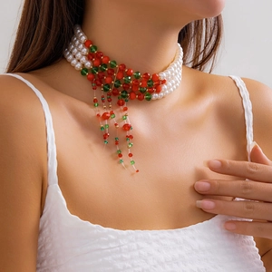 Close-up of layered Christmas choker with red and green beads and pearl tassels