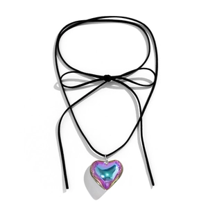 Close-up of heart-shaped iridescent pendant on black velvet cord choker necklace