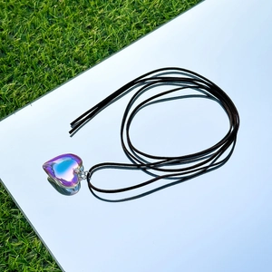 Macro shot of an aurora borealis crystal heart pendant on an adjustable cord necklace