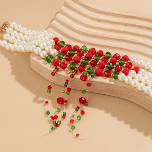Detail of multi-layer beaded Christmas choker with festive red and green drop tassels
