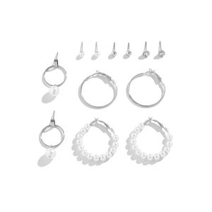 Flat lay of 6-pair silver earring set with faux pearls and rhinestones on white background
