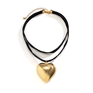 Close-up of double-layer black choker necklace with polished gold heart pendant