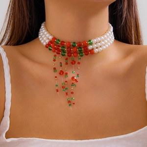 Three-layer faux pearl choker with festive red and green bead accents and tassels