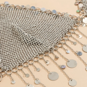 Detail of silver mesh body chain featuring sparkling rhinestones and hanging metal sequins