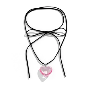 Detail of pink resin heart pendant with adjustable black cord bow tie necklace