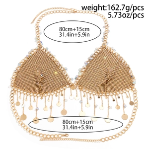 Detail of gold rhinestone body chain vest with star sequins and tassels on white background