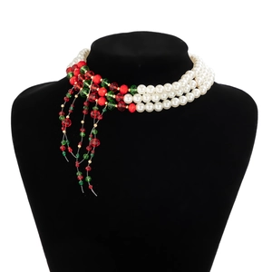 Close-up of triple-layer gothic choker with white pearls and red green beaded tassels
