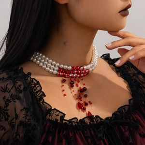 Macro view of triple-layer pearl choker with red blood drip fringe pendant details