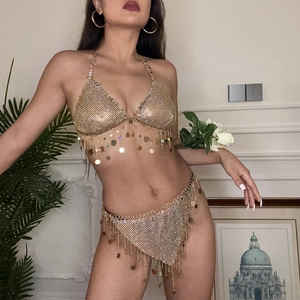 Close-up of gold metal mesh bikini body chain with shimmering fringe and sequin details