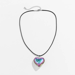 Close-up of holographic heart pendant with gradient colors on black cord necklace
