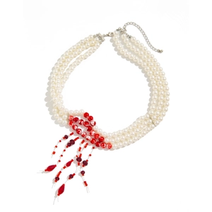 Close-up of gothic choker with white pearls and red blood drop bead tassel fringe