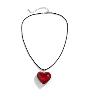 Close-up of translucent red heart pendant with black rope chain and adjustable silver clasp