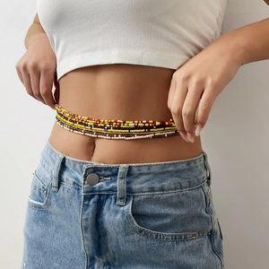 Detail of colorful bohemian beaded waist chain set for beach jewelry styling on a model