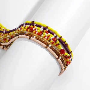 Detail of multi-layered colorful seed beads and red crystal on beach body chain set