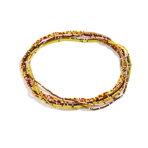 Detailed view of layered colorful bead body chains in bohemian style for summer beachwear
