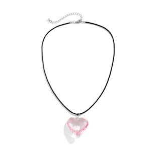 Detailed view of pink heart-shaped resin pendant with black cord and silver clasp