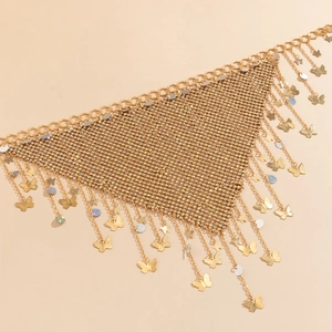 Detail of gold rhinestone mesh body chain with butterfly charms and fringed tassels