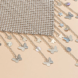 Detail of silver mesh body chain with fringe, butterfly charms and sequin accents