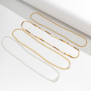 Detail of four-piece beaded waist chain set with sea shells and pearls for beach wear