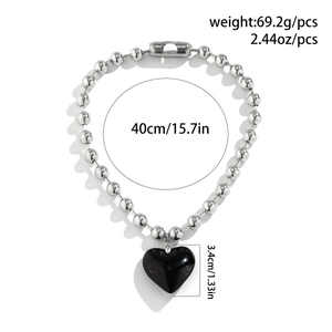 Macro view of silver bead chain necklace with black heart pendant and size dimensions