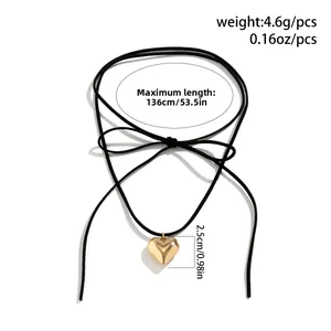 Detailed view of adjustable wax cord choker with a polished gold heart pendant