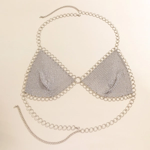 Detail of silver rhinestone body chain with sequin stars and mesh tassel fringe