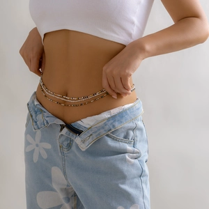 Detailed close-up of Bohemian multi-layer waist beads with sea shells and colorful beads
