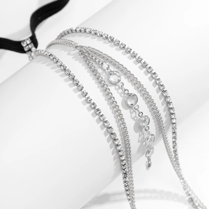 Macro detail of multi-layered silver choker with rhinestones and elastic black band