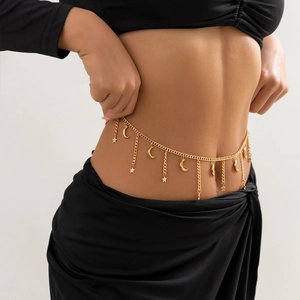 Detail of golden belly chain featuring shiny metallic crescent moon and star pendants