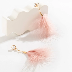 Detail of pink feather drop earrings with pearls and gold chain on a white display